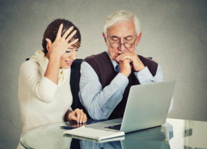 Woman Showing Older man Computer