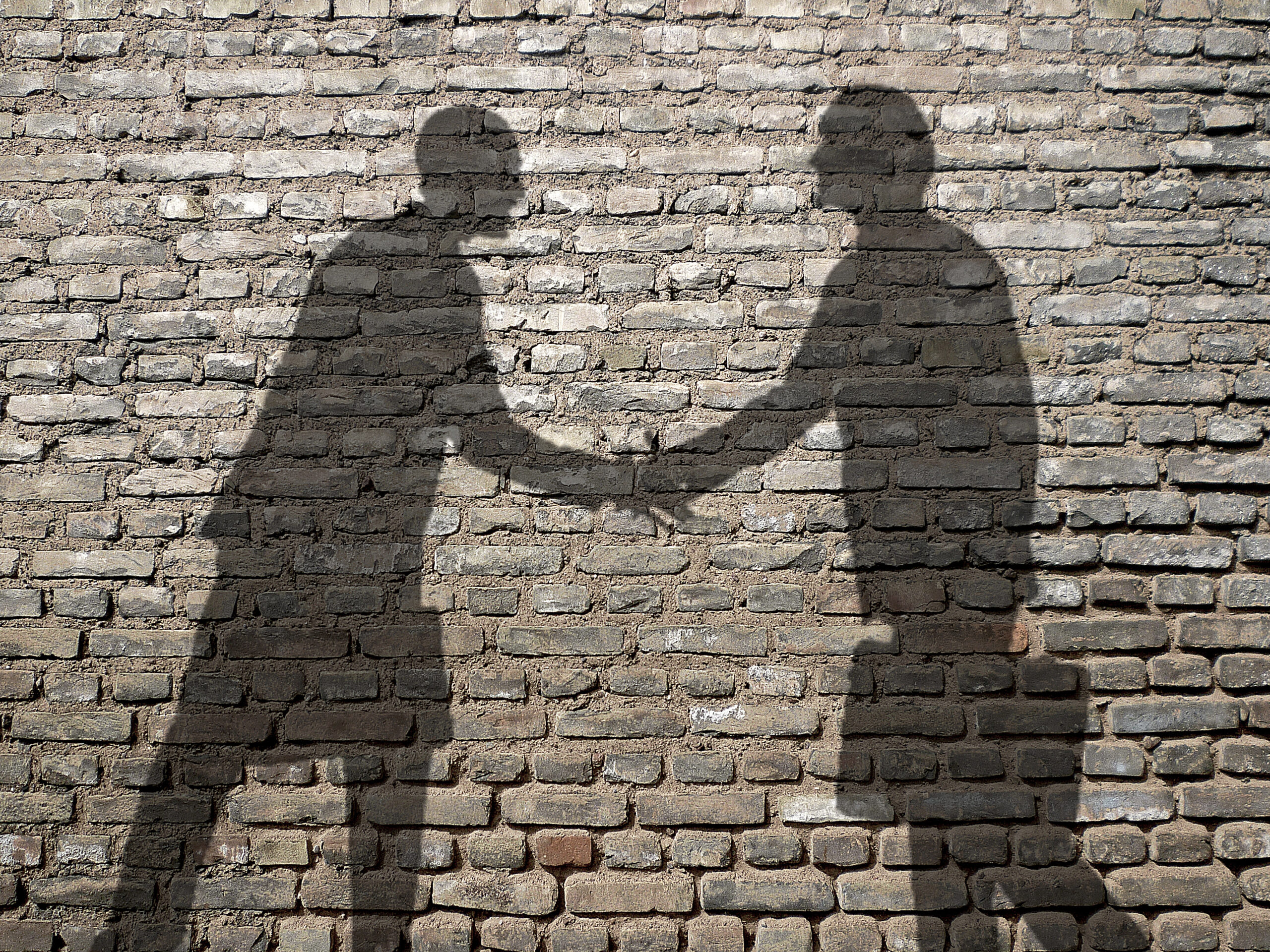 Shadow of two men shaking hands