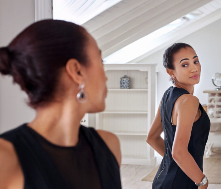 A businesswoman looking at herself in the mirror