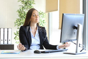 Woman meditating doing Yoga at desk