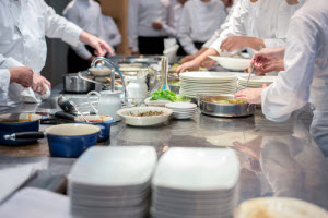 A group of chefs preparing the food