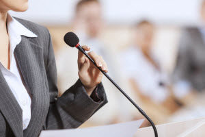 A person speaking on a microphone