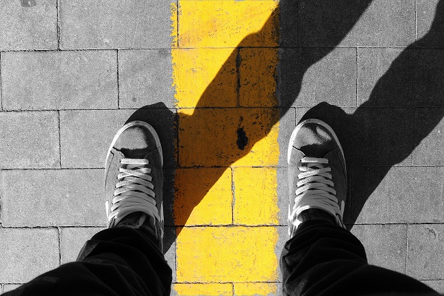 A person standing in a boundary line