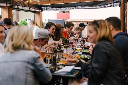 People talking while eating at a restaurant