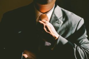 A person fixing his tie