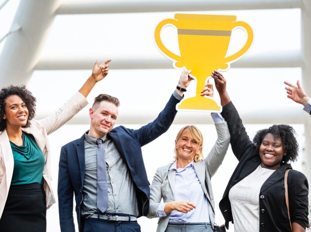 Business Team holding trophy