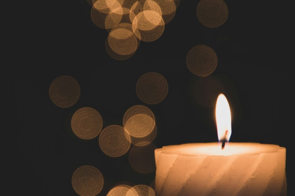 A calm candle scene symbolizing grief, reflection, and emotional support during the holidays.