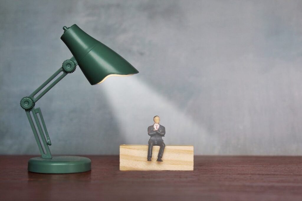 miniature of a man under a lamp used as a spotlight
