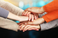 hand of team in a huddle