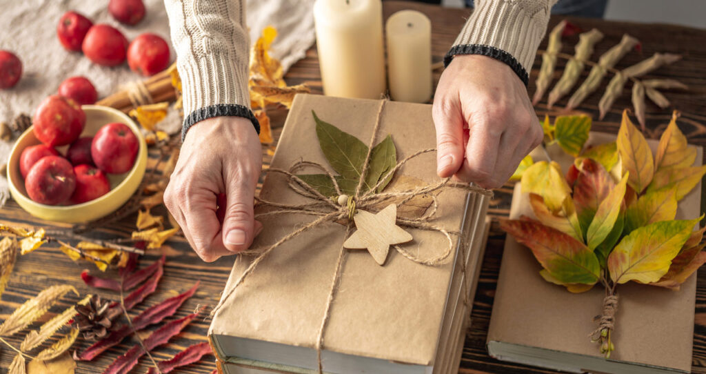 Hands of a woman tying up a decorative book