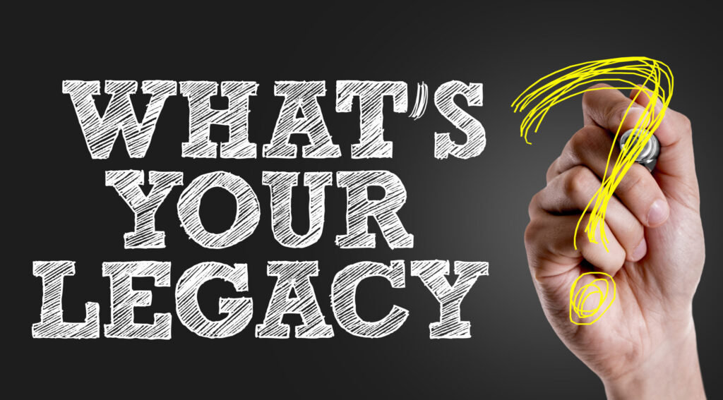 A person writing "What's Your Legacy?"