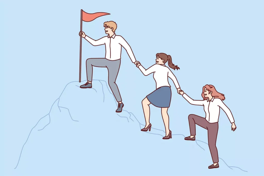 People helping each other climb the top