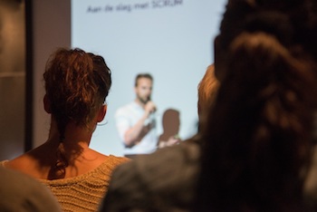 A person speaking in front of a crowd